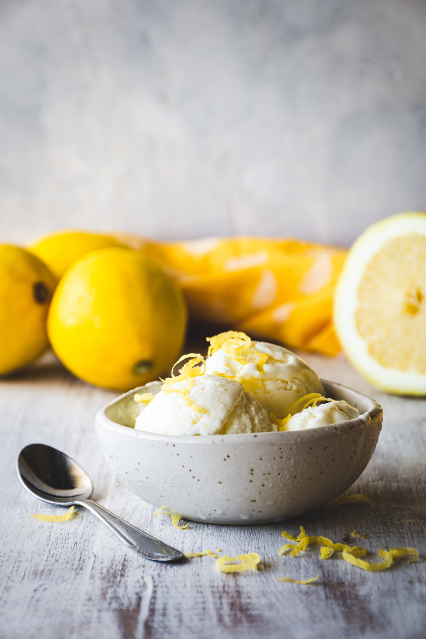 fresh lemon ice cream with lemons in the background